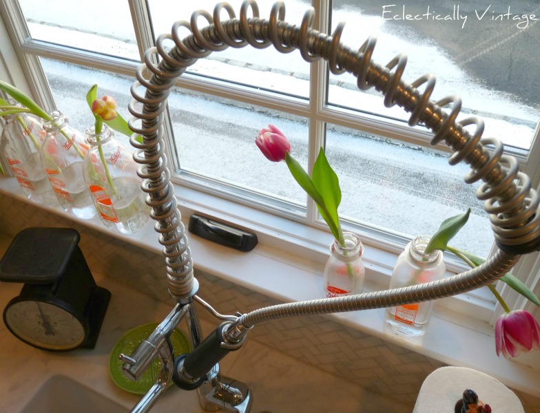 Restaurant style faucet - great touch of industrial in this farmhouse style white kitchen.  kellyelko.com