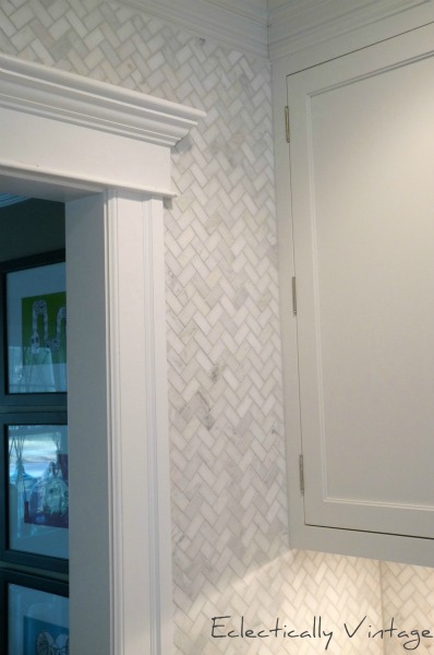 Herringbone marble tile to the ceiling for a custom look in this kitchen.  eclecticalyvintage.com