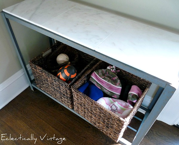 Top a console table with marble tiles for an inexpensive fix!  kellyelko.com