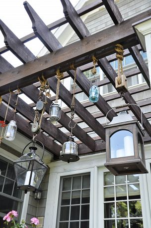 Love these Pottery Barn lantern knockoffs - fun hanging from the pergola kellyelko.com