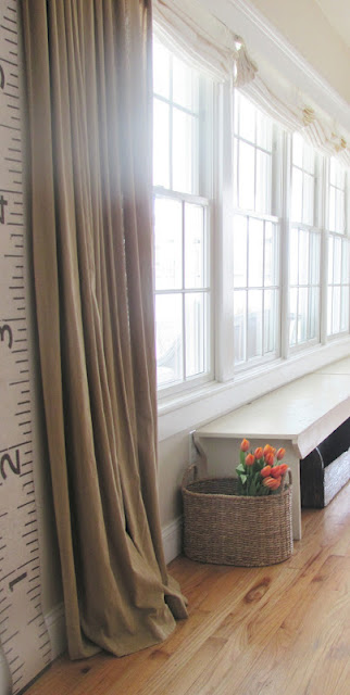 Neutral drapes and a fun growth chart in this stunning coastal home kellyelko.com