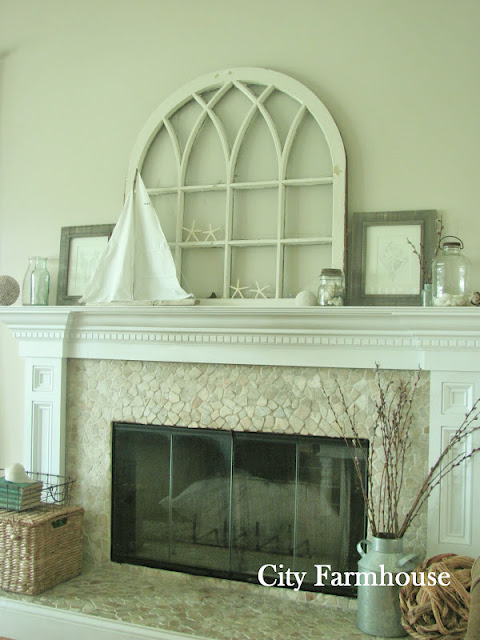 Love this coastal mantel with vintage window and stone fireplace surround kellyelko.com