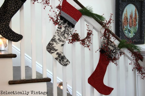 Christmas House Tours - step inside this 100 year old home filled with tons of fabulous decorating ideas like this stocking bannister!  kellyelko.com