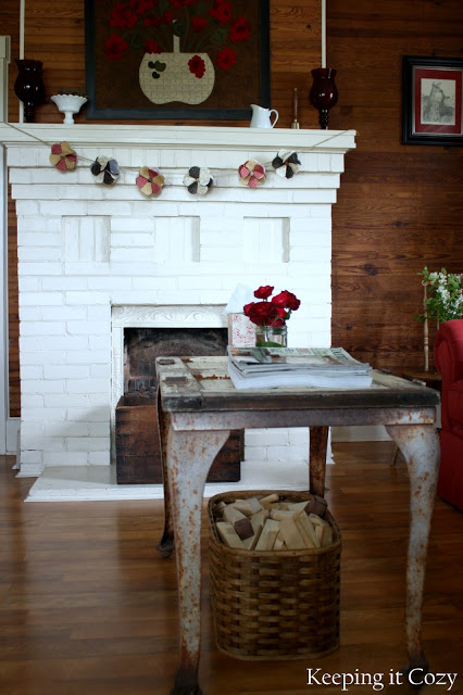 Great metal table and fireplace in this old farmhouse 