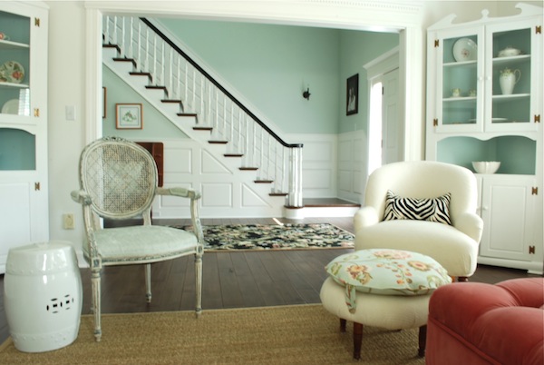 Fabulous living room - tranquil blue walls and a pink ottoman!