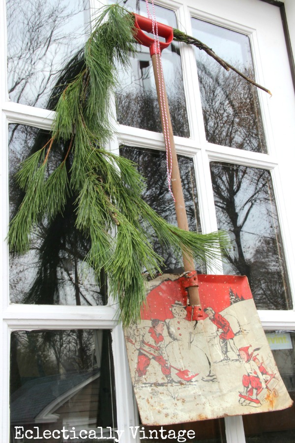 Christmas House Tours - step inside this 100 year old home filled with tons of fabulous decorating ideas like this vintage toy snow shovel wreath!  kellyelko.com