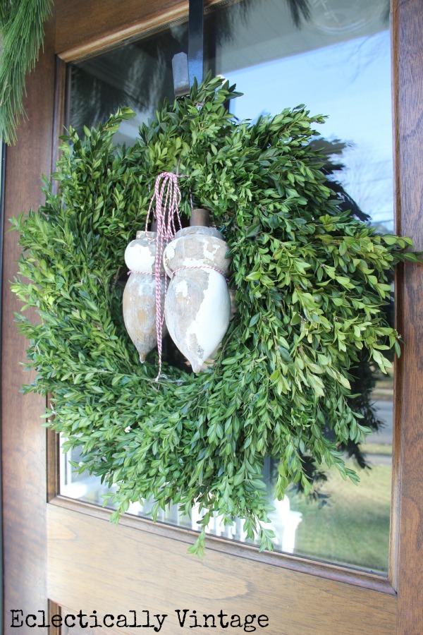 Love a classic boxwood wreath for Christmas and the antique finials add the perfect touch kellyelko.com