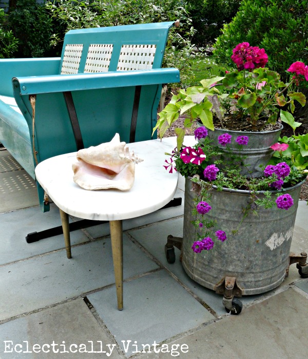 Love the old blue porch glider and galvanized bucket planters kellyelko.com