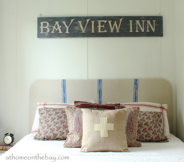 Cottage tour filled with fabulous decorating ideas like this DIY French Grainsack Headboard!