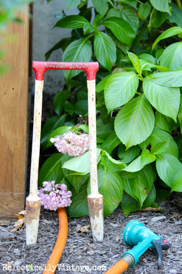 Vintage croquet set wicket - used as a hose guide!  You have to see how she used the rest of the set in her house!  kellyelko.com