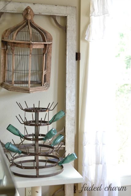 Antique bottle drying rack in this cottage dining room