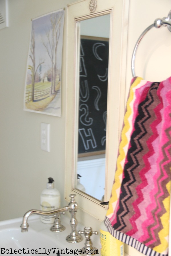 Small powder room carved in a nook under the stairs kellyelko.com