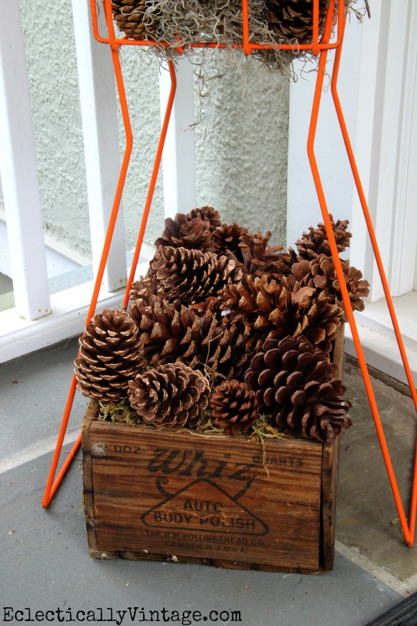 Pinecones in a vintage crate - see more of this fall porch kellyelko.com