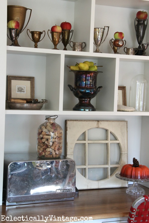 Beautiful shelf arrangement - love the collection of loving cups.  kellyelko.com