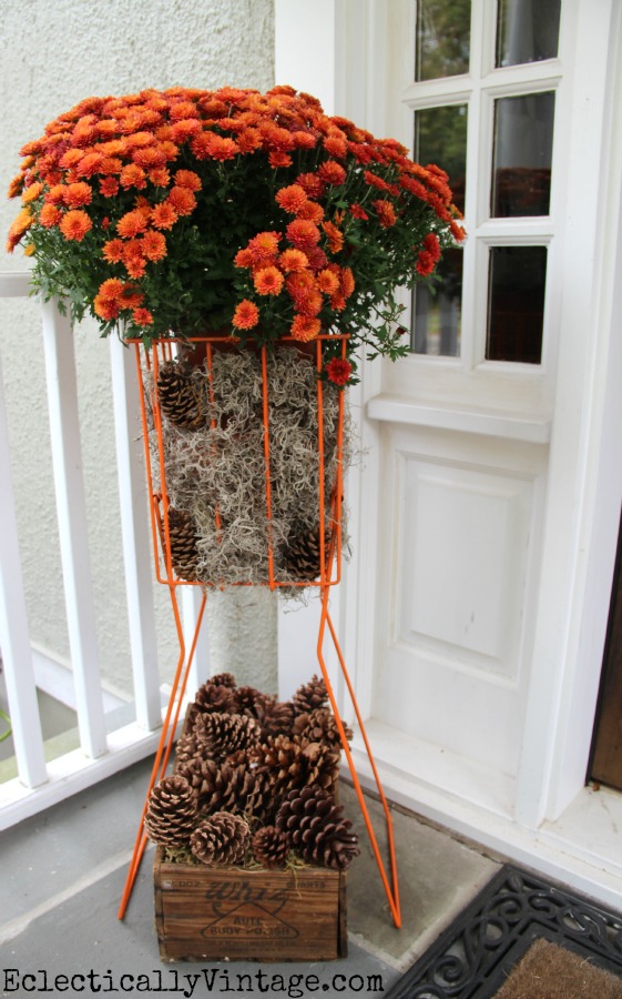 Fabulous idea - a tennis ball hopper #planter!  See more of this #fall porch kellyelko.com