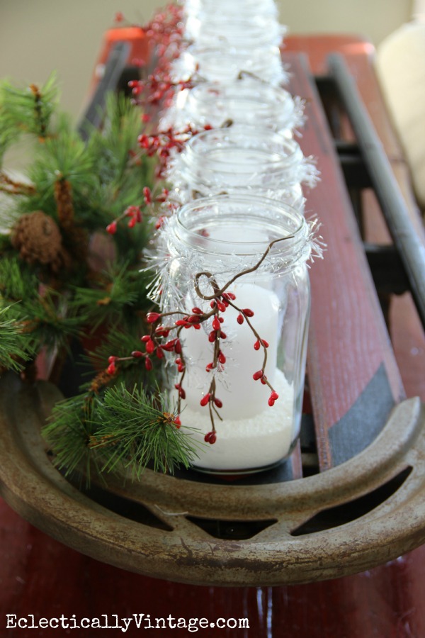 Vintage sled holds a row of snowy mason jar candles kellyelko.com