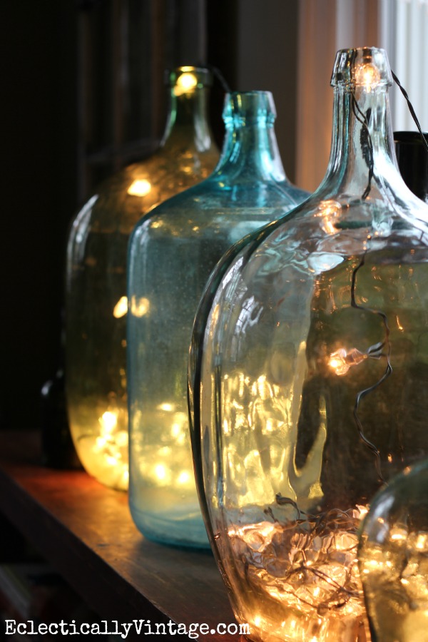 Demijohn bottles filled with string lights for Christmas kellyelko.com