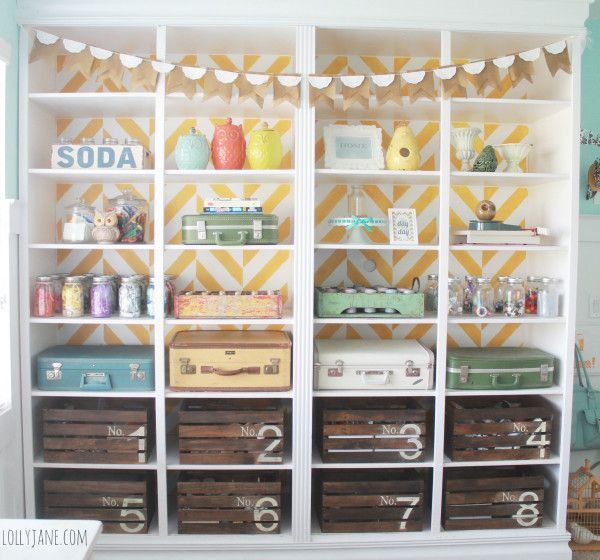 Love the vintage suitcase & crate storage in this craft room