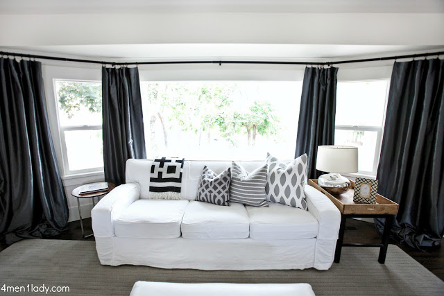 Love the white sofa against the dark drapes