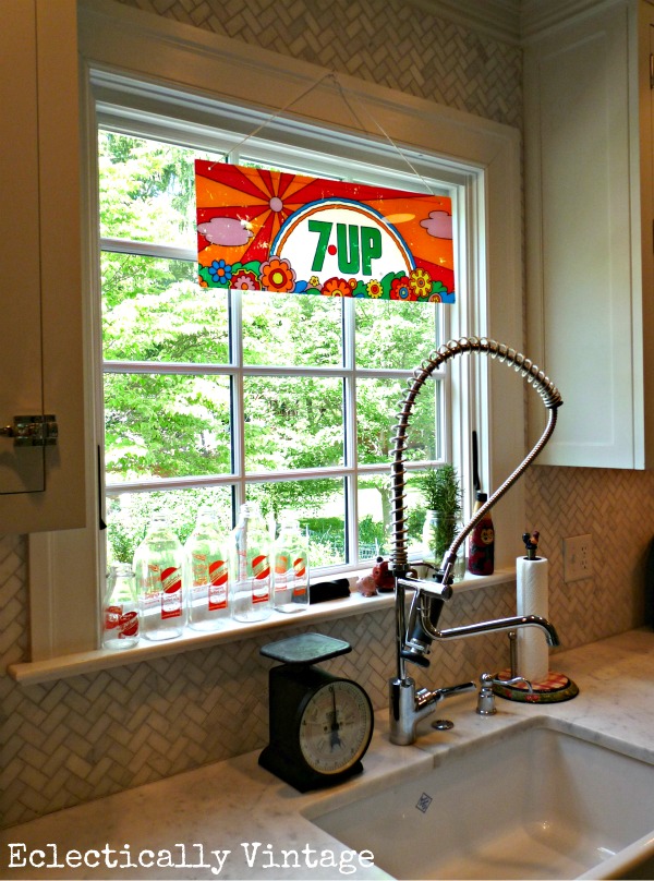 Vintage Peter Max 7Up sign in this beautiful white kitchen kellyelko.com