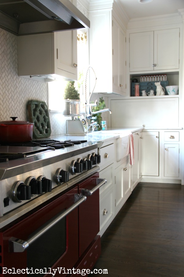 Beautiful white kitchen with a red stove! kellyelko.com