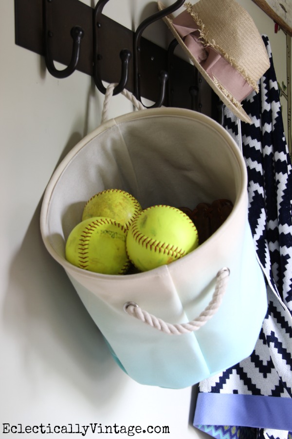 Great storage ideas in this small mudroom - hang a canvas basket on a coat rack! kellyelko.com