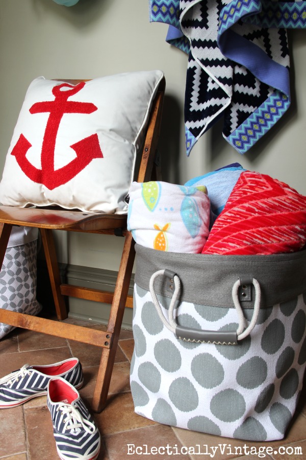 What a cute summer mudroom with great storage ideas - and I love that anchor pillow! kellyelko.com