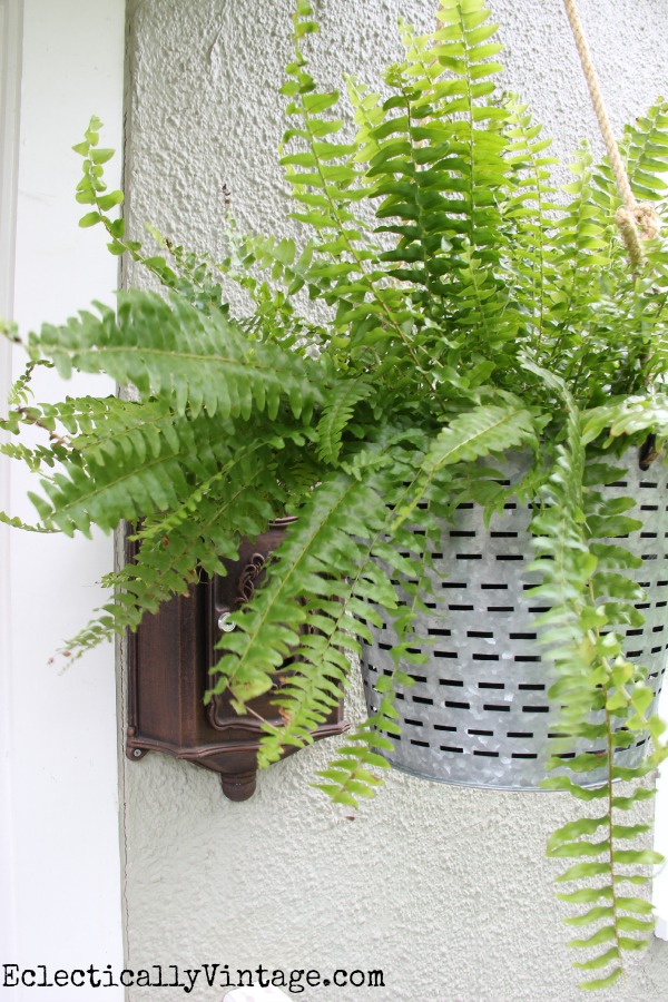 What a unique hanging planter idea!  Looks great on this porch kellyelko.com