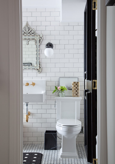 Beautiful bathroom with classic subway tile - love the mirror and brass fixtures kellyelko.com