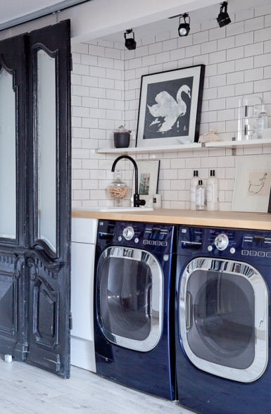 Hidden laundry room behind antique sliding doors kellyelko.com