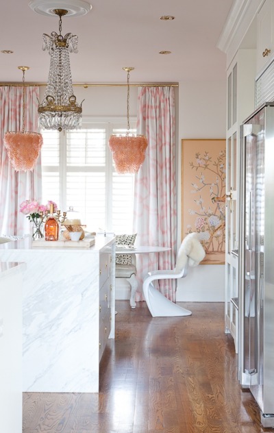 Amazing white kitchen with pale pink accents - love the twin pink chandeliers kellyelko.com