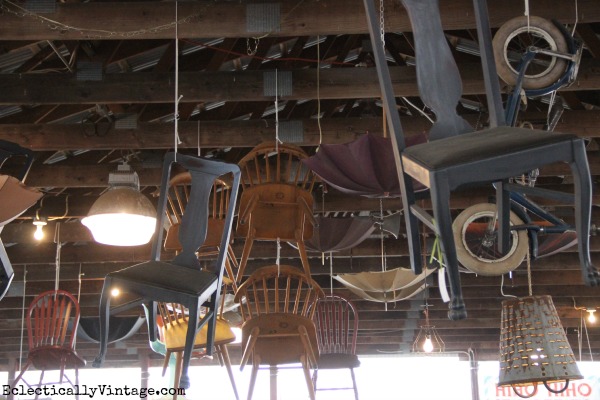 Vintage chairs hanging from the ceiling - what a cute display! kellyelko.com