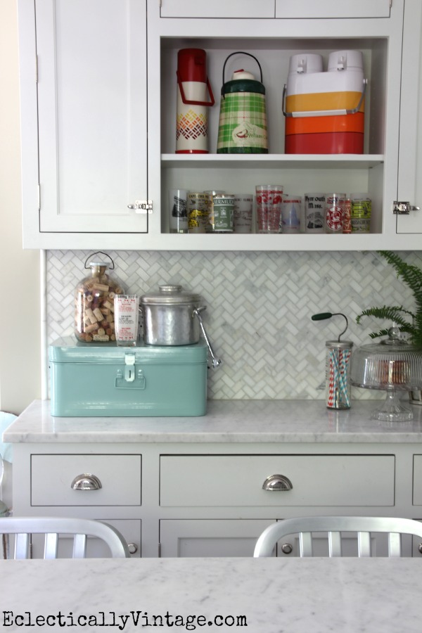 Love the carrara marble backsplash and the colorful vintage collections! kellyelko.com