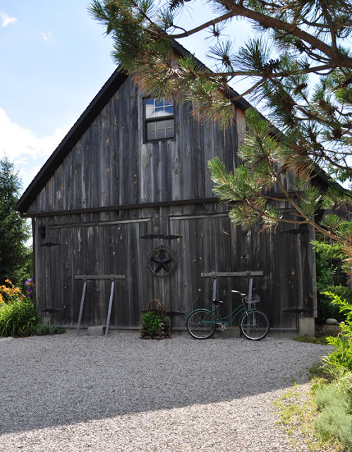 Beautiful weathered barn in this whimsical garden kellyelko.com