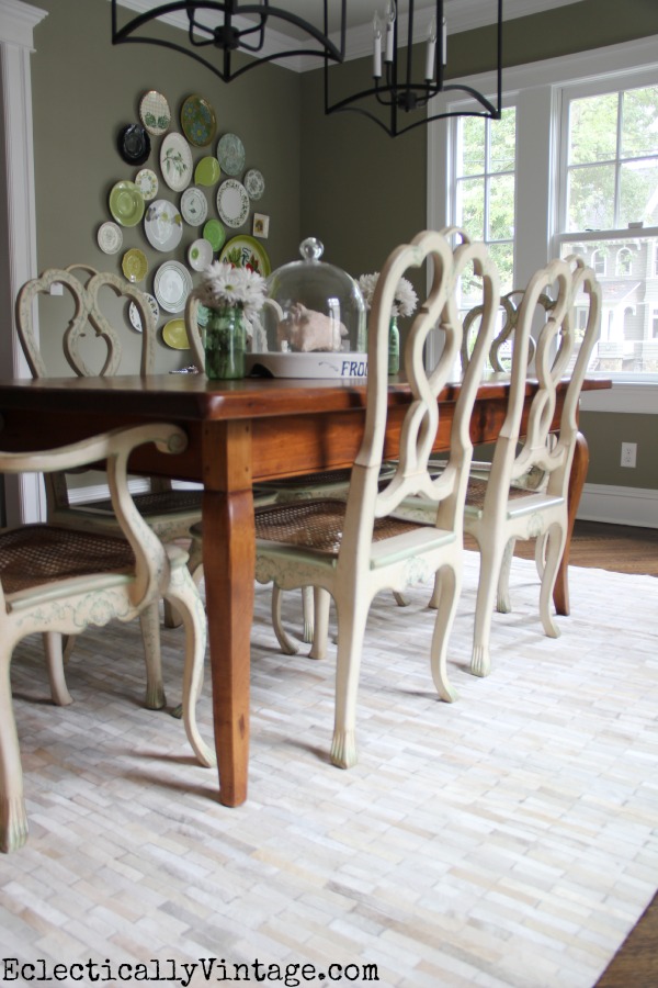 Love this eclectic dining room - from the colorful gallery wall to the twin lanterns to that amazing pieced cowhide rug! kellyelko.com