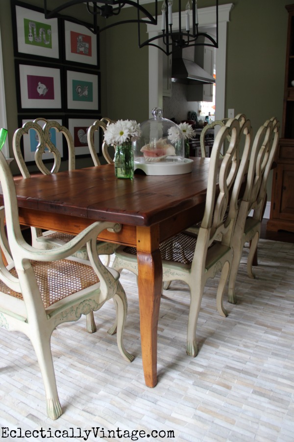 Love this eclectic dining room - from the colorful gallery wall to the twin lanterns to that amazing pieced cowhide rug! kellyelko.com