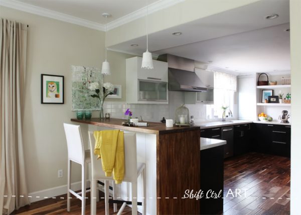 Love the layout of this kitchen and the peninsula with the wood wrapping around the side kellyelko.com