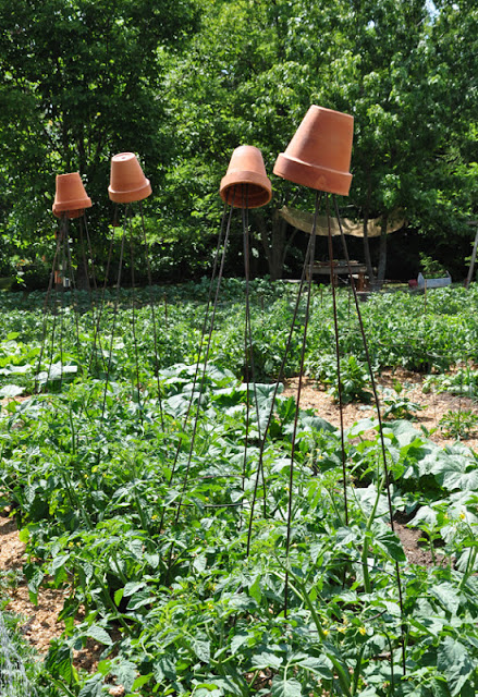 Terra cotta pot trellis toppers on this whimsical garden tour kellyelko.com