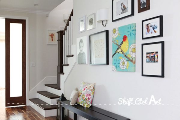 Beautiful staircase remodel and entry with a fun gallery wall kellyelko.com