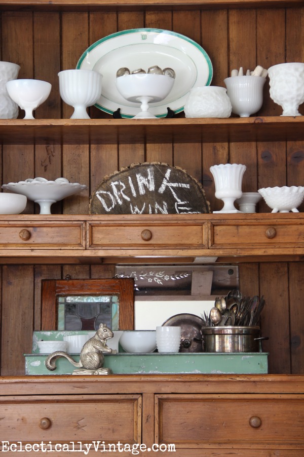 Vintage milk glass displayed in a hutch kellyelko.com