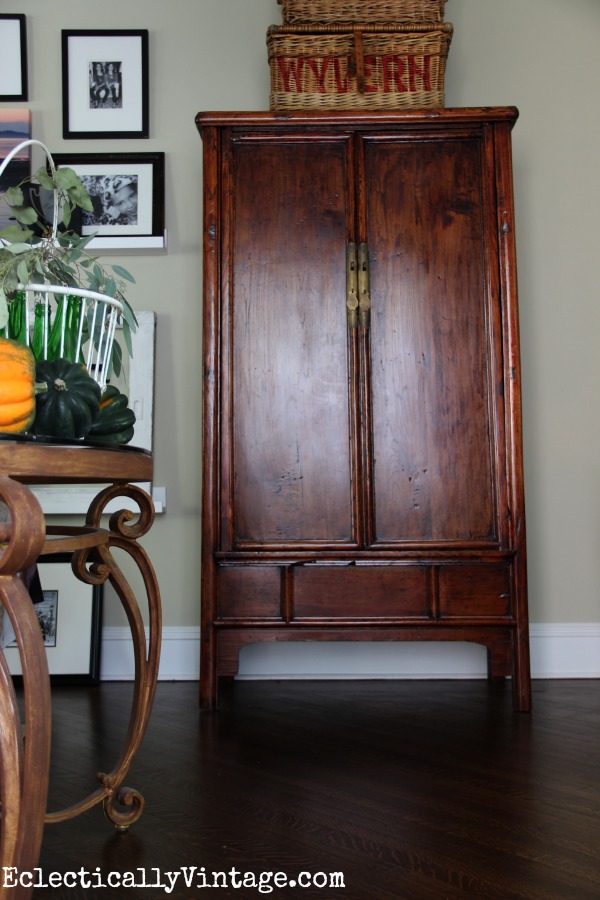 Asian armoire - love the old baskets stacked on top kellyelko.com