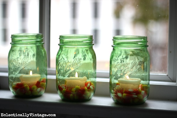 Super cute idea - candy corn mason jar candles kellyelko.com #EclecticallyFall