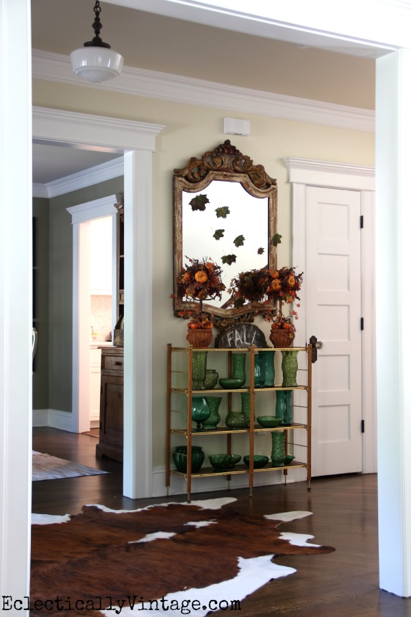 What a fun fall foyer - love the falling leaves on the mirror kellyelko.com #EclecticallyFall