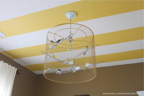 Fun striped ceiling and birdcage chandelier in this nursery kellyelko.com