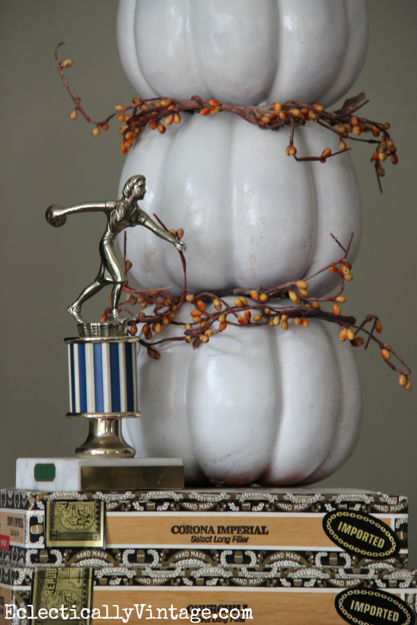 Cute pumpkin topiary - love it propped on the old cigar boxes kellyelko.com #EclecticallyFall