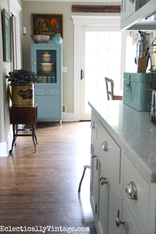 Love the vintage blue medical cabinet in this beautiful white kitchen eclecticalyvintage.com #EclecticallyFall