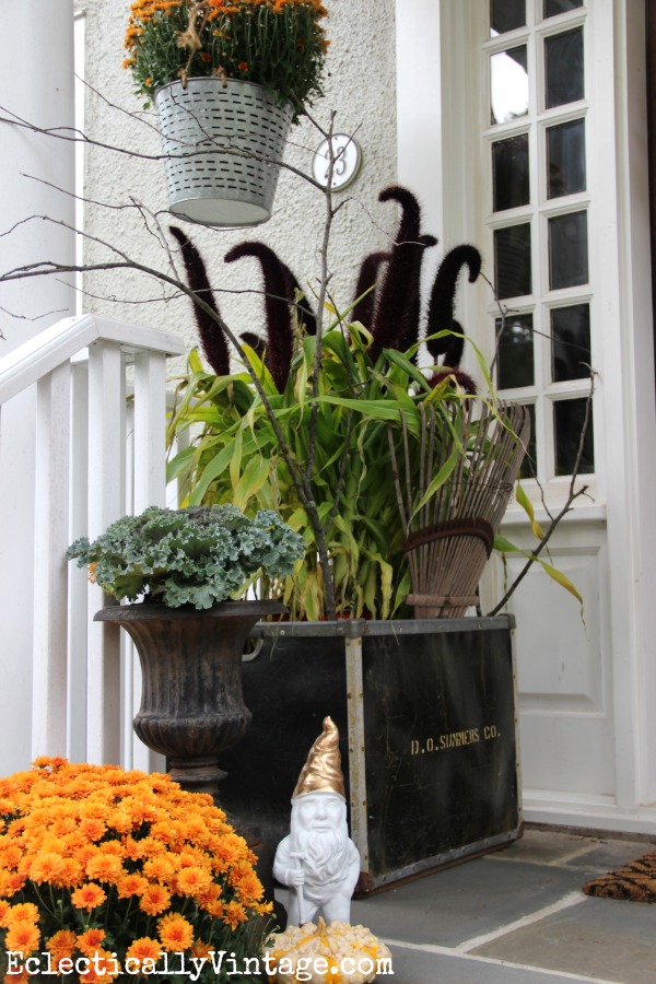 I love this fall porch! That huge planter with the cool plant is amazing! kellyelko.com