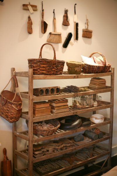 A vintage bakers rack is perfect for display - love the old hand broom collection kellyelko.com