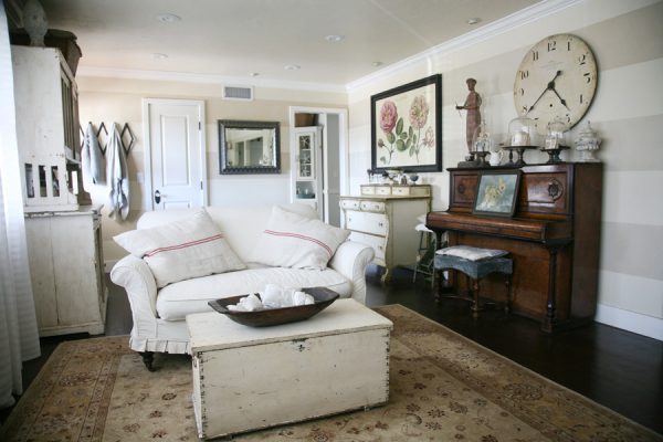 Casual living room filled with vintage collections - love the old piano and huge clock! kellyelko.com