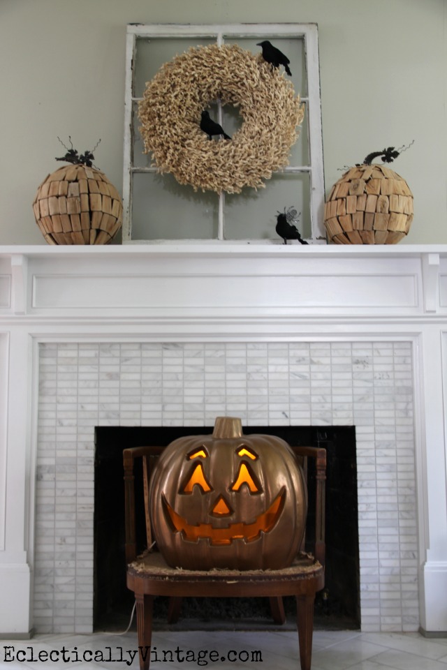 Halloween mantel - a few black crows on a wreath and a copper jack o lantern turn fall into Halloween kellyelko.com